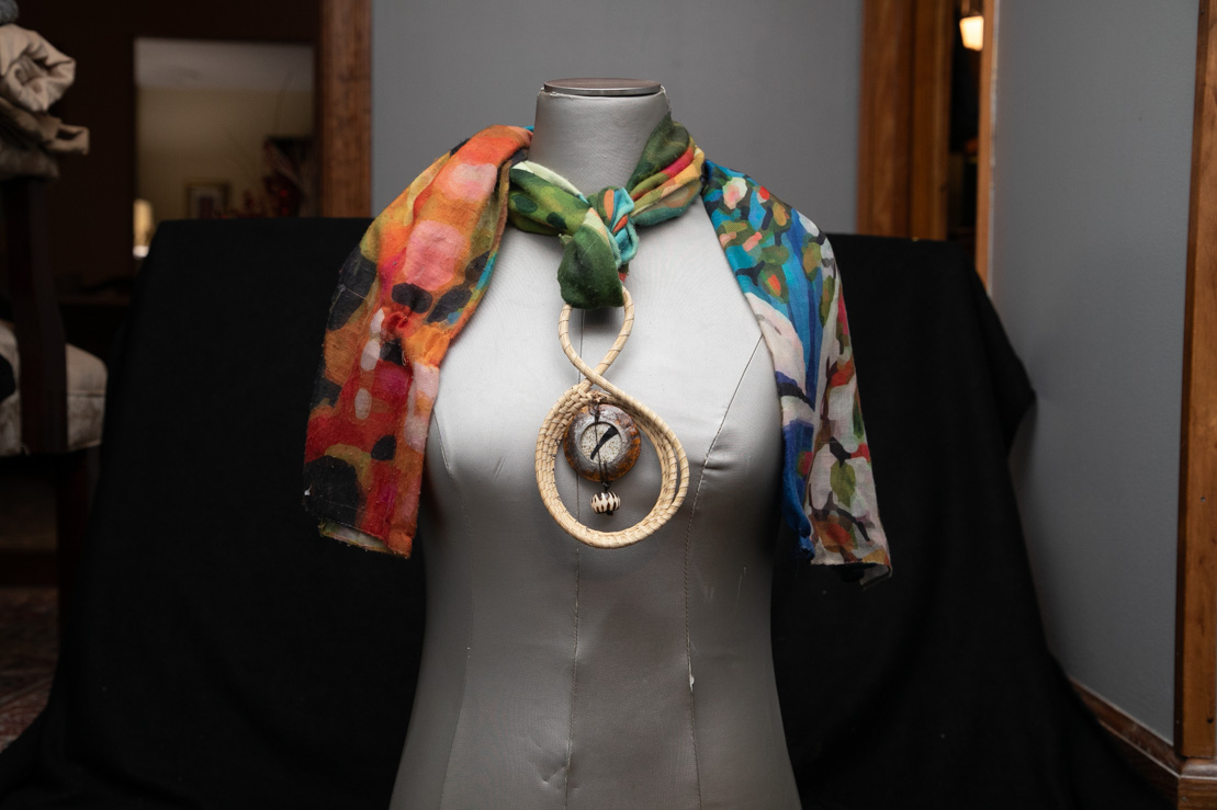 Sweetgrass pendant necklace styled with a silk scarf
