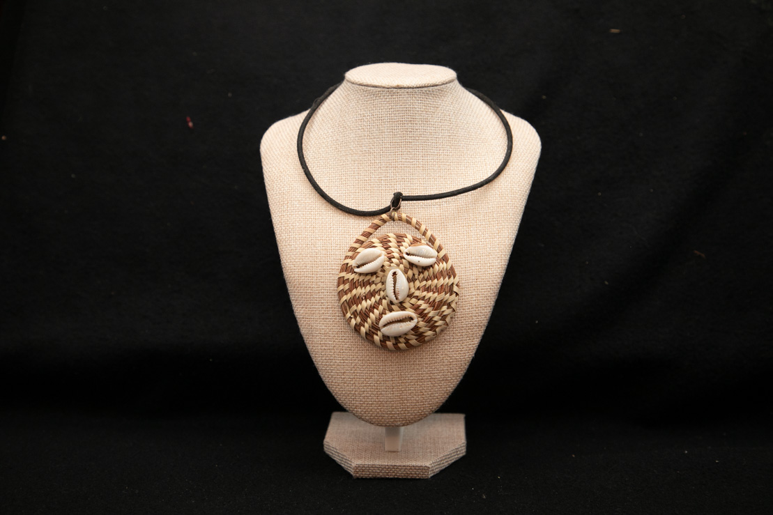 Sweetgrass pendant with cowrie shells on a cord necklace