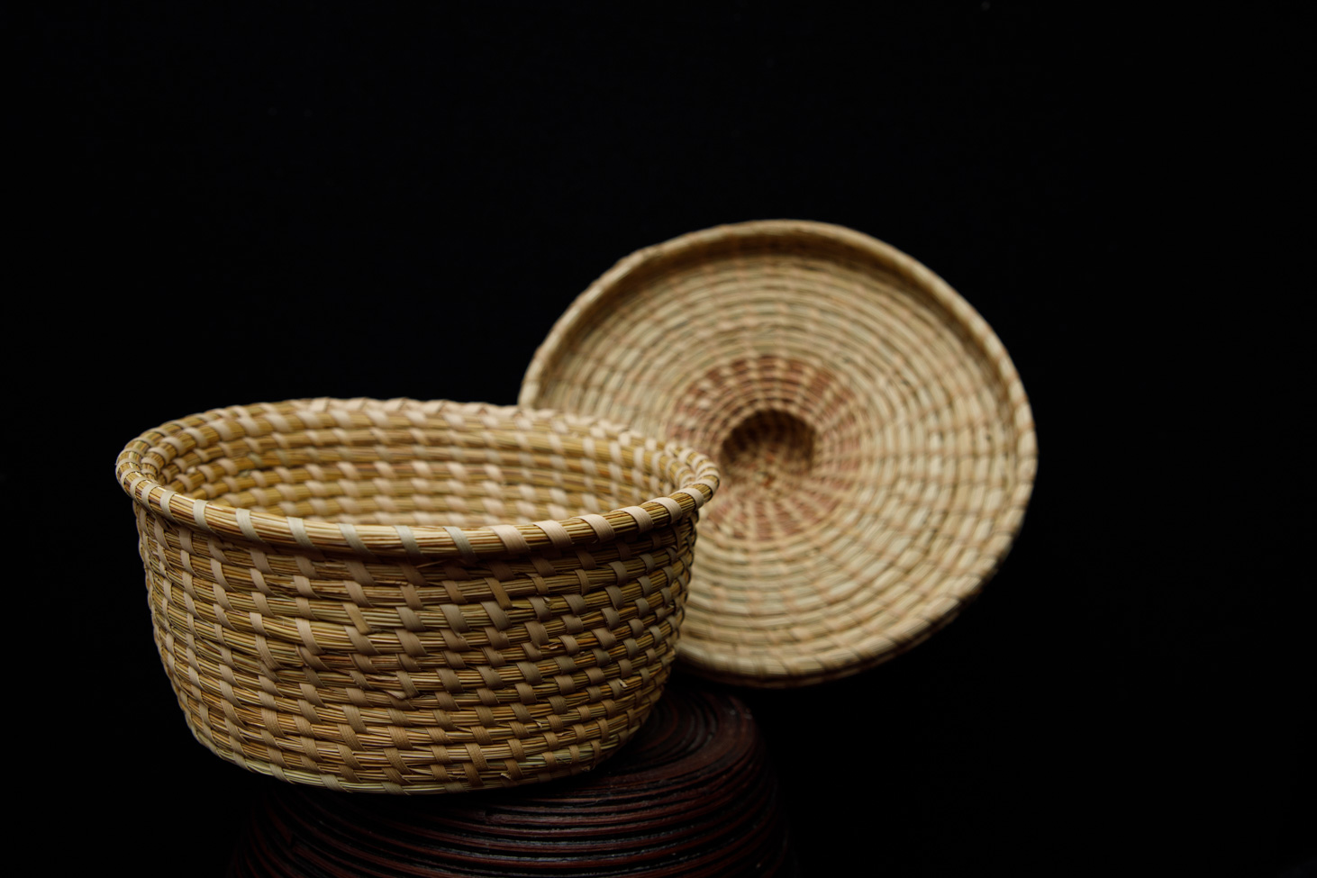 Sweetgrass cover basket with its lid set beside it